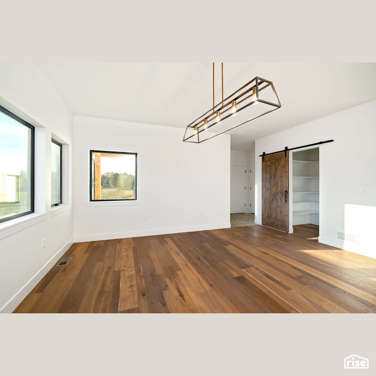 Dining room with wood sliding door with Engineered Hardwood by Revolve Design Build