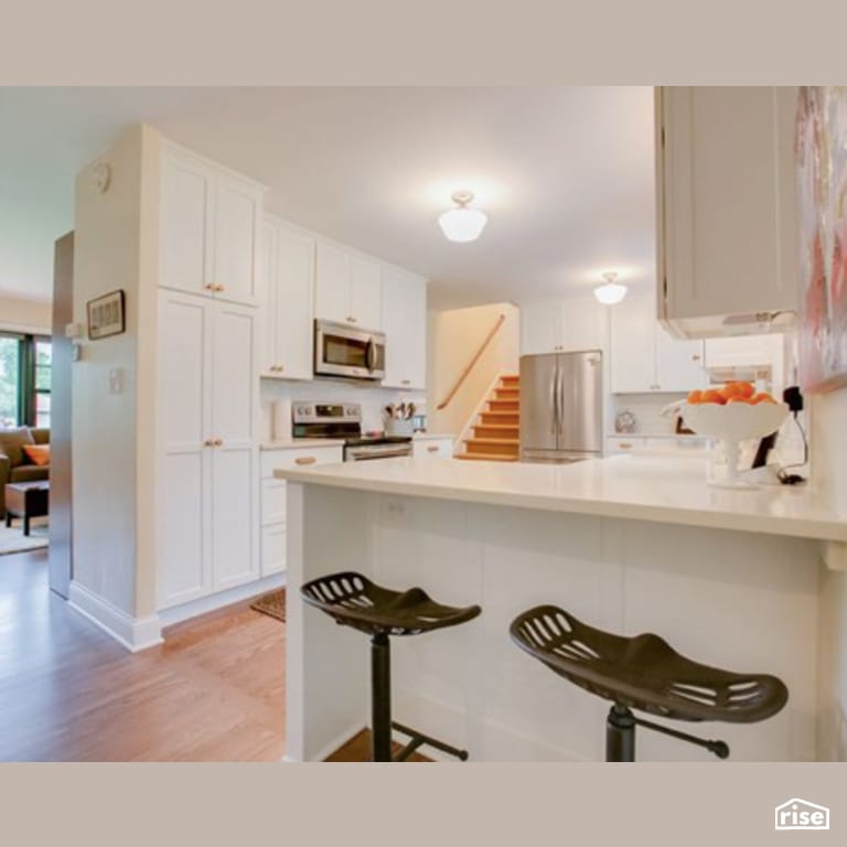 Kitchen with Laminate Flooring by Constructive Builders