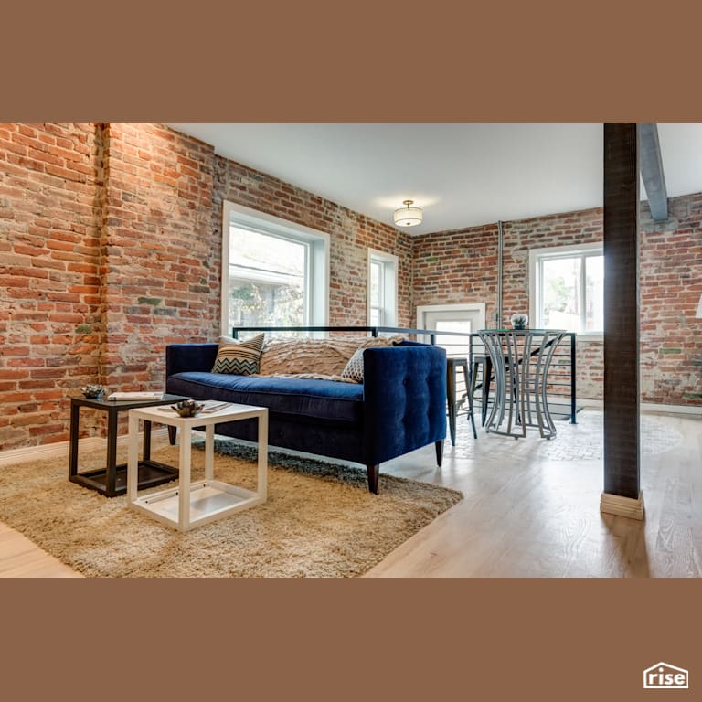 Living room with exposed brick with FSC Certified Hardwood by Alpen High Performance Products