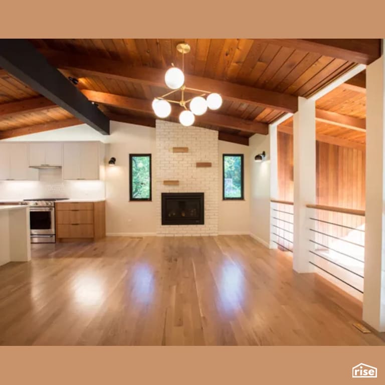 Living Room with Laminate Flooring by Constructive Builders