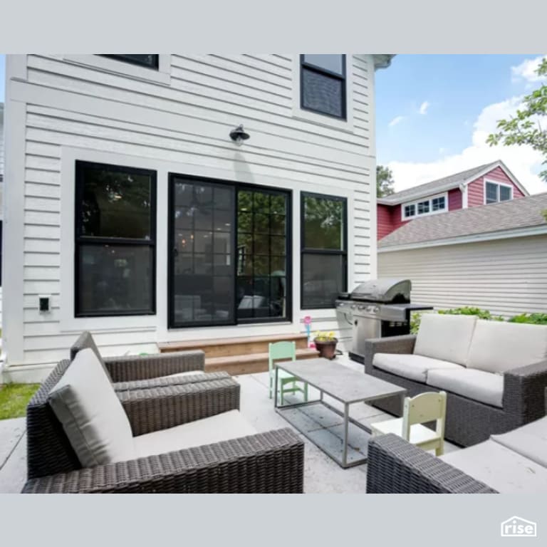 Back Patio with Wall Mounted Outdoor Lighting by Constructive Builders