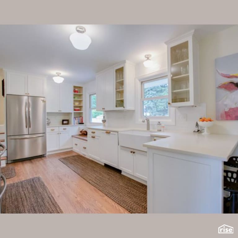 Kitchen with Laminate Flooring by Constructive Builders