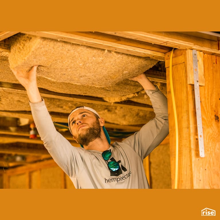 Pressing HempWool Into Place with Hemp Batt Insulation by Hempitecture
