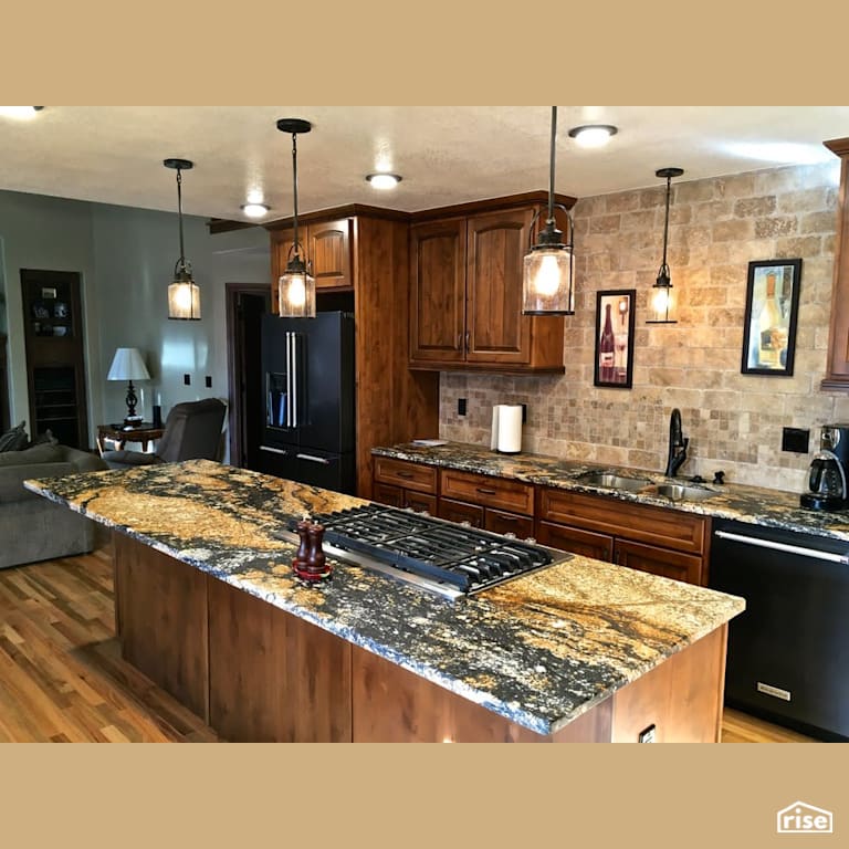 Open concept wood grain kitchen with beautiful countertops with Integrated LED by Revolve Design Build