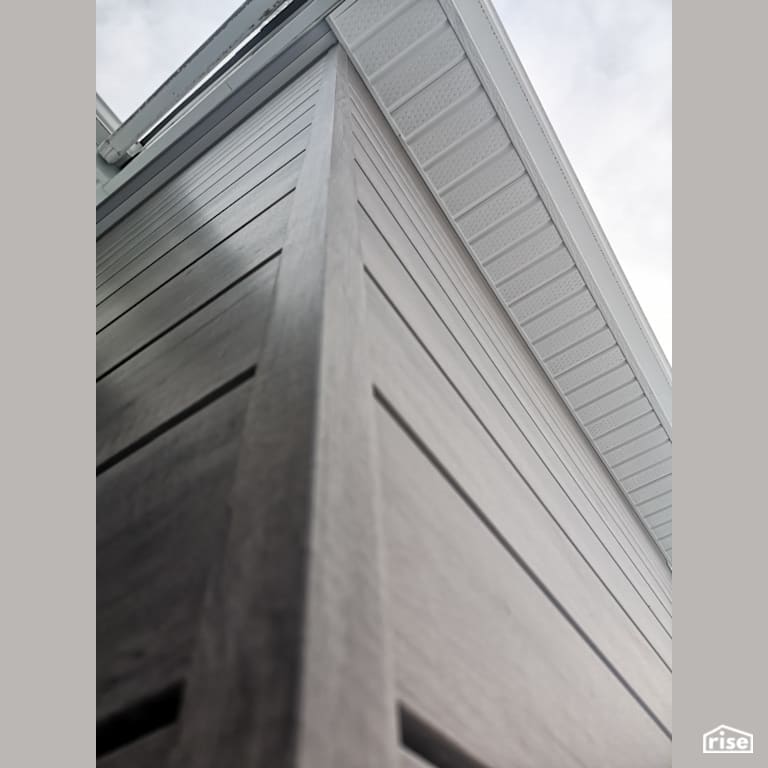 Composite corner with soffits with Composite or Engineered Siding by ChamClad by Chameleon