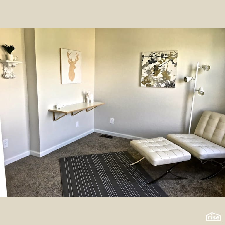 Home office with comfortable lounging chair with Carpeting by Revolve Design Build