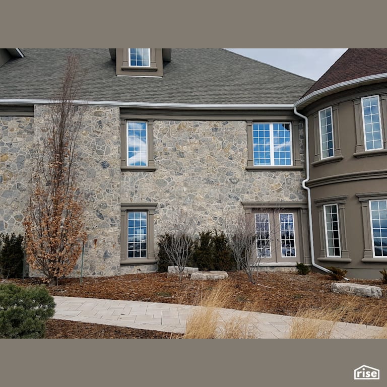Two story stone sided home stone walkway with Asphalt Shingles by Masonal Stone Inc