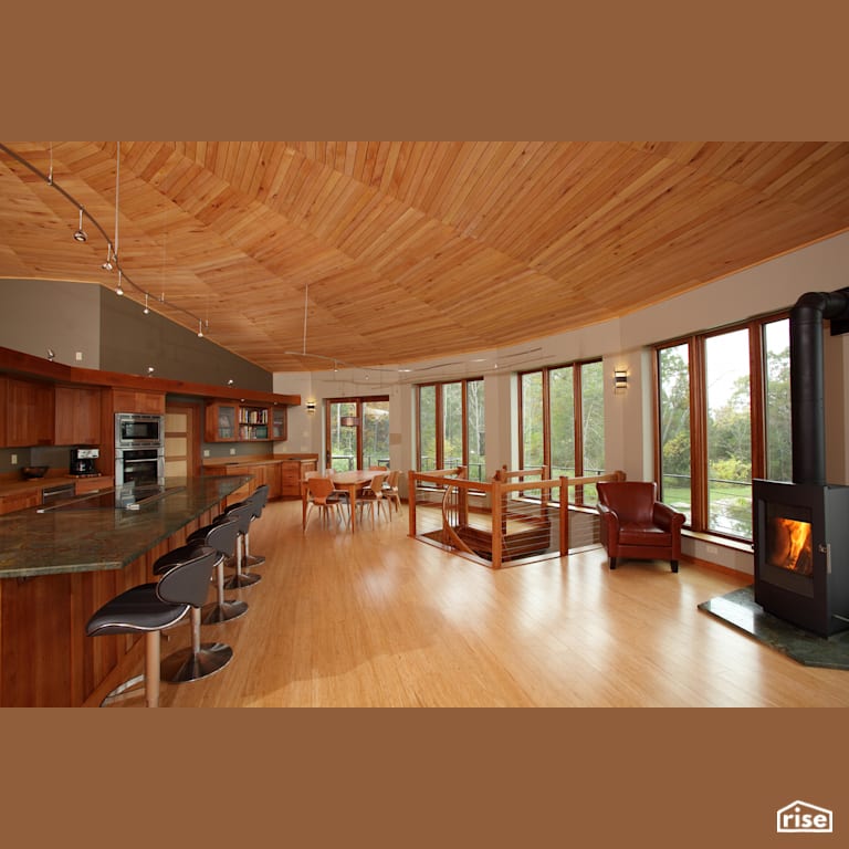 Open dining area with wood stove with Accent Outdoor Lighting by Deltec Homes