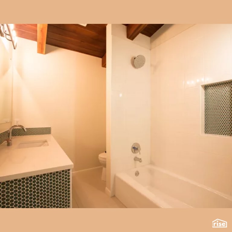 Bathroom with Low-Flow Showerhead by Constructive Builders