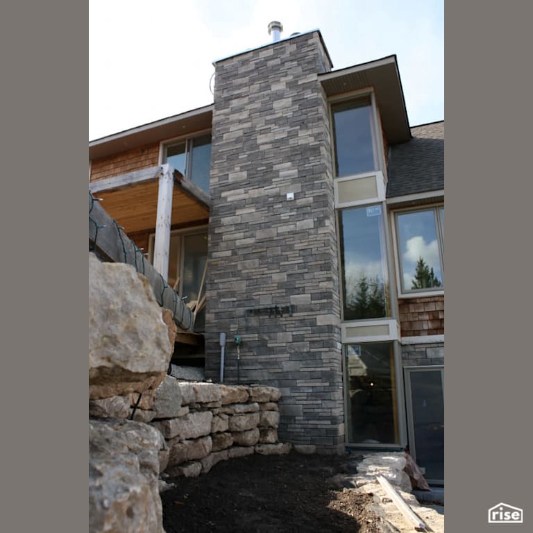 Stone chimney with Wood Shingles by Masonal Stone Inc