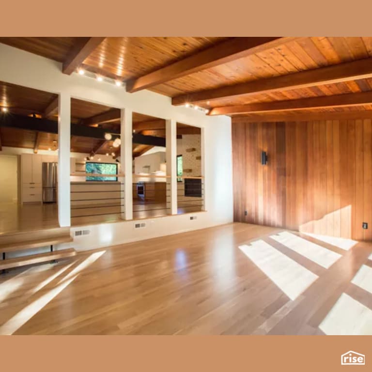 Family Room with Laminate Flooring by Constructive Builders