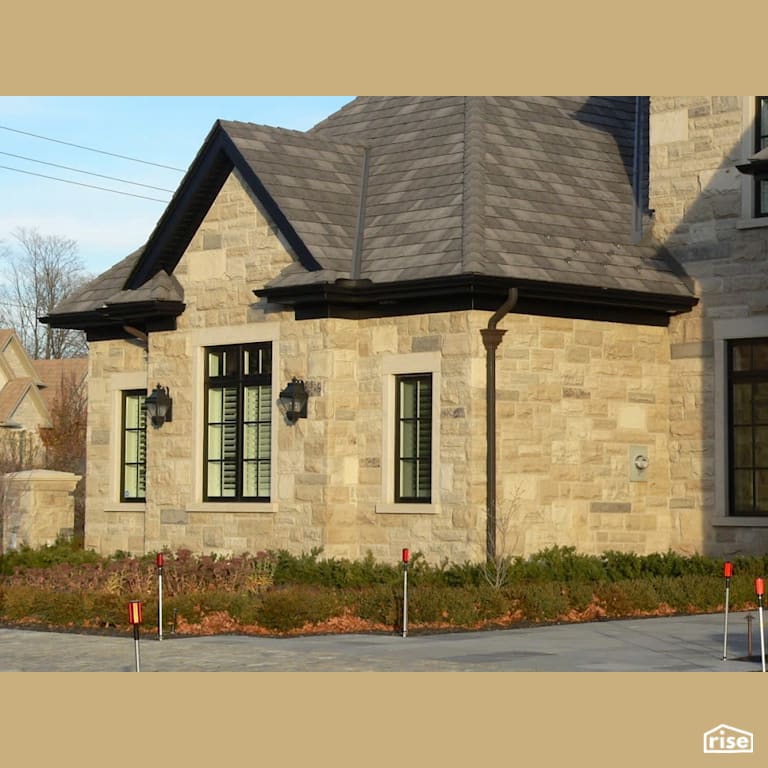 House with Stone Siding with Asphalt Shingles by Masonal Stone Inc