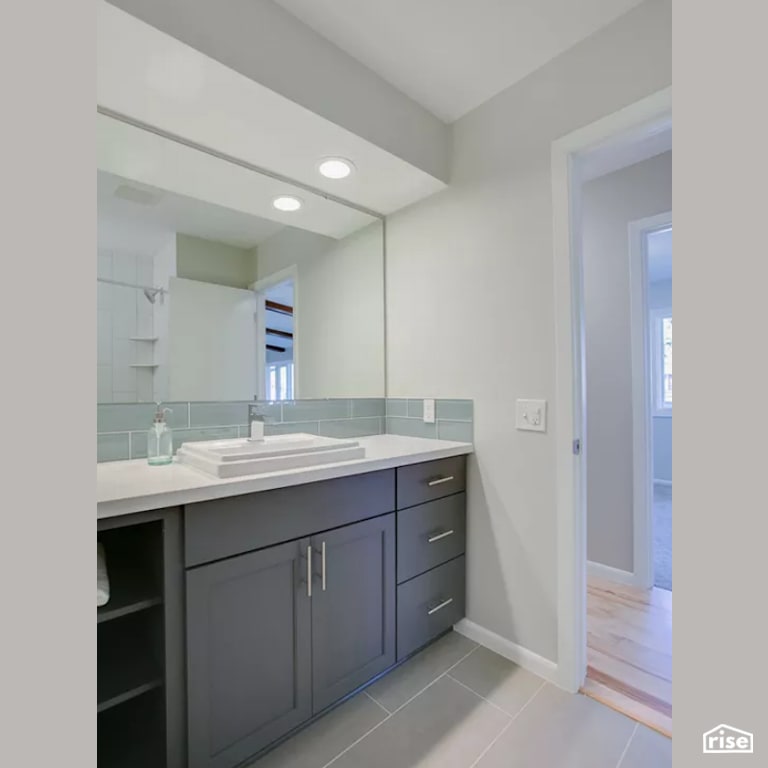 Bathroom with Wood Veneer Cabinet by Constructive Builders