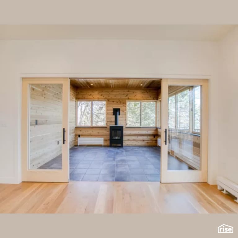 Sunroom with Wood Stove by Constructive Builders