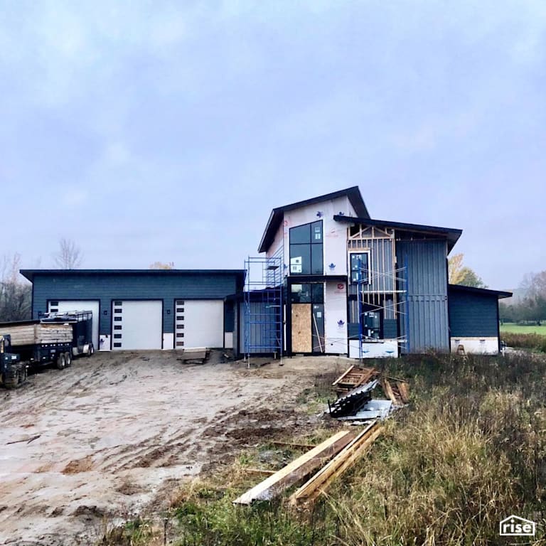In Progress Exterior With Shipping Container Integration with Double Hung Window by Three Squared Inc.