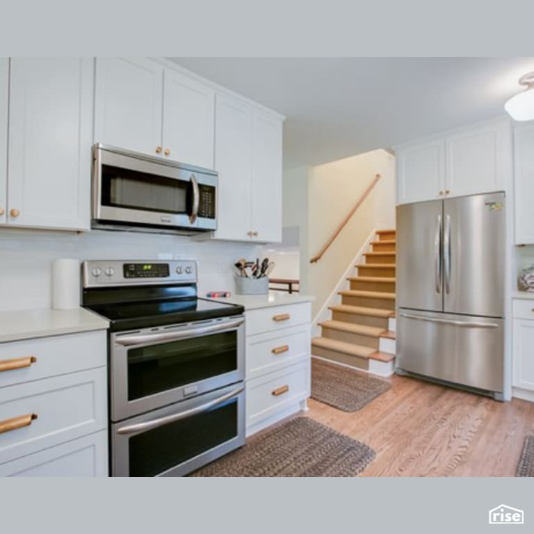 Kitchen with Laminate Flooring by Constructive Builders