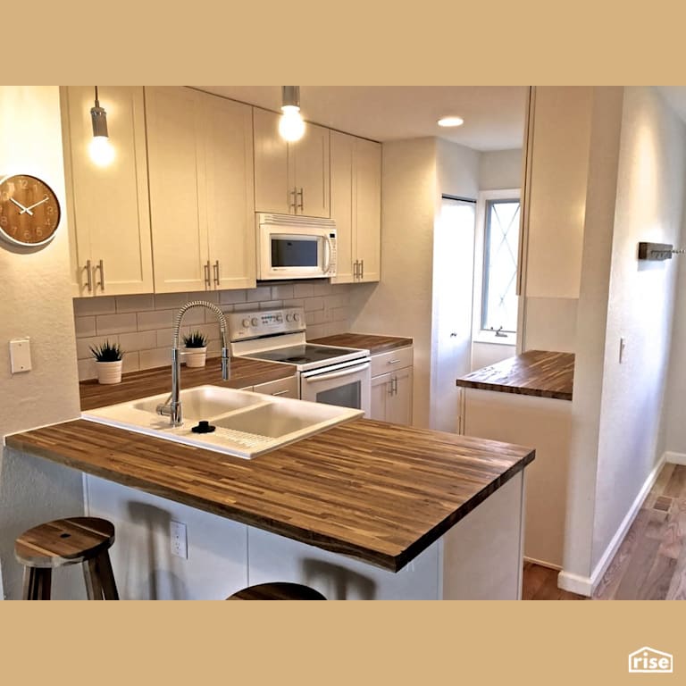 Kitchen with hardwood countertop with FSC Certified Solid Wood Countertop by Revolve Design Build