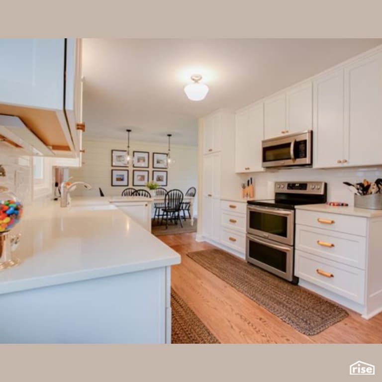 Kitchen with Laminate Flooring by Constructive Builders