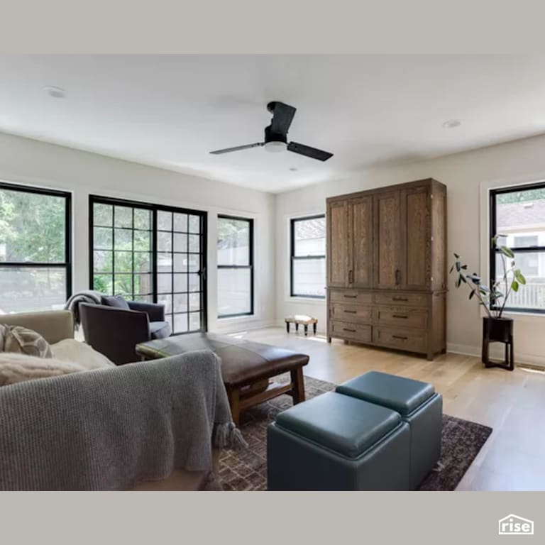 Family Room with Laminate Flooring by Constructive Builders