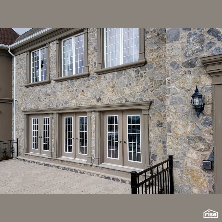 Stone sided building with multiple patio doors with Stone Siding by Masonal Stone Inc