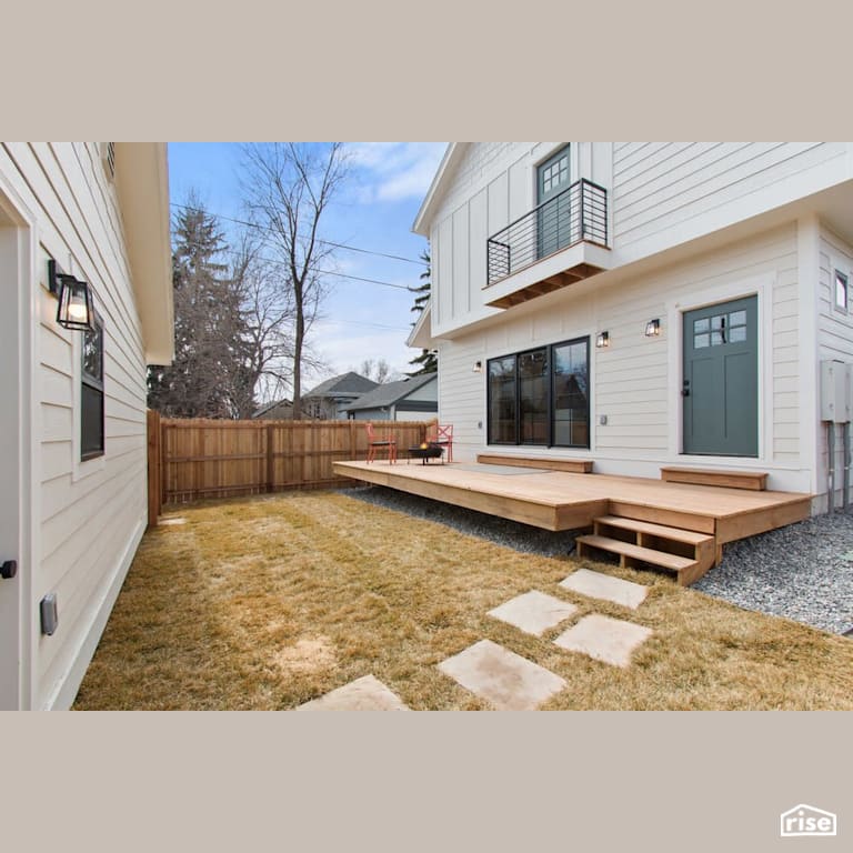 Pressure treated rear deck with Clapboard Wood Siding by Revolve Design Build