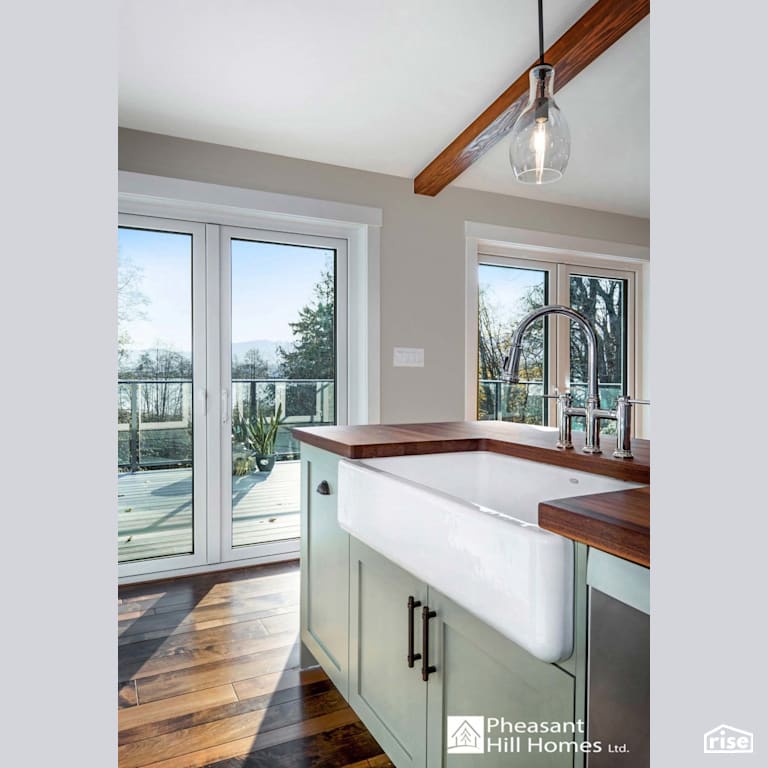 Kitchen View with Low-Flow Kitchen Faucet by Pheasant Hill Homes Ltd.