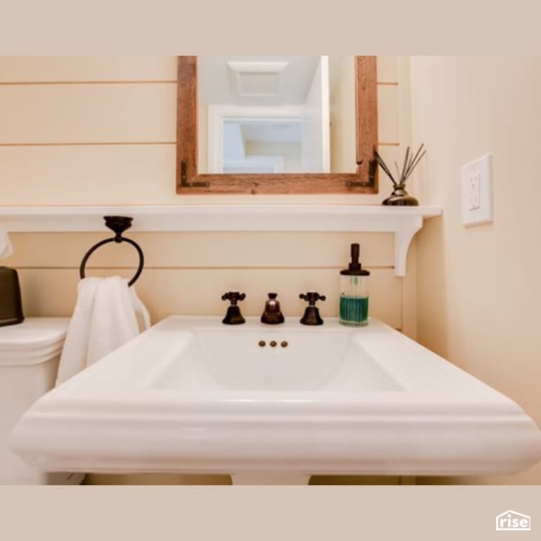 Clapboard Bathroom with Low-Flow Bathroom Faucet by Constructive Builders