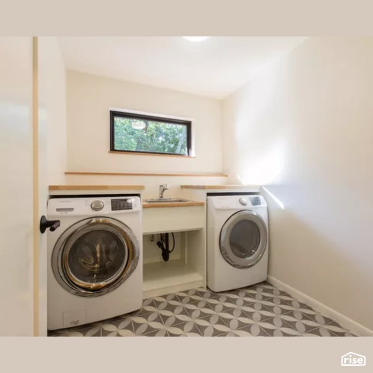 Laundry Room with Low-Flow Bathroom Faucet by Constructive Builders