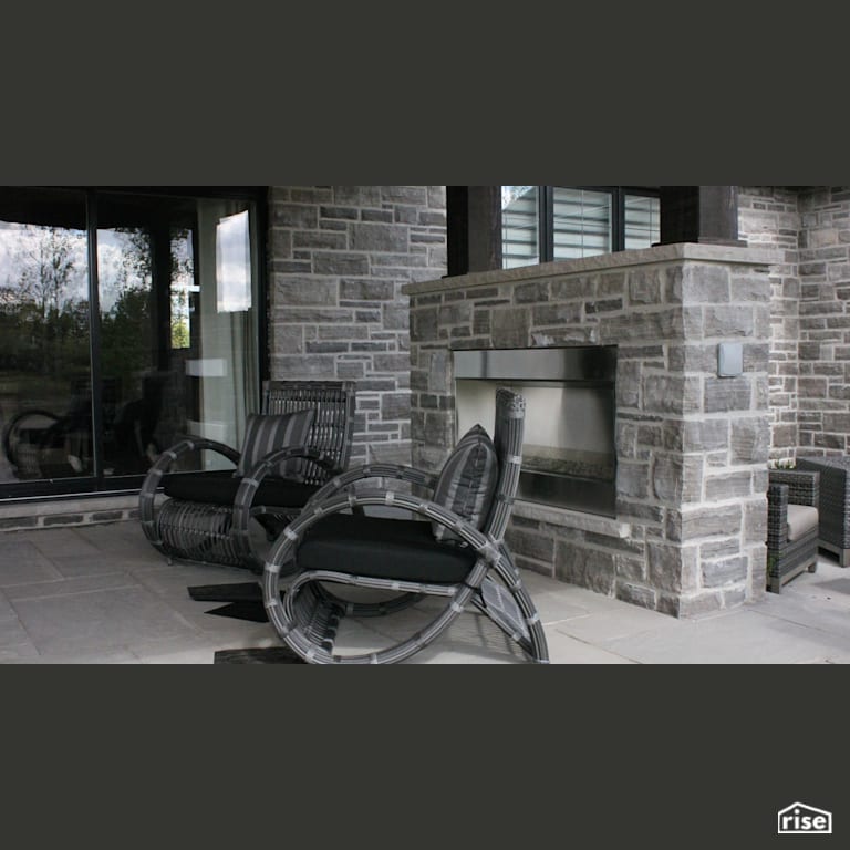 Custom stone patio with outdoor fireplace with Stone Siding by Masonal Stone Inc