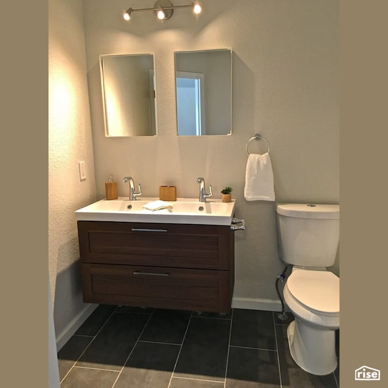 Wall hung vanity with dual flush toilet with Wood Veneer Cabinet by Revolve Design Build