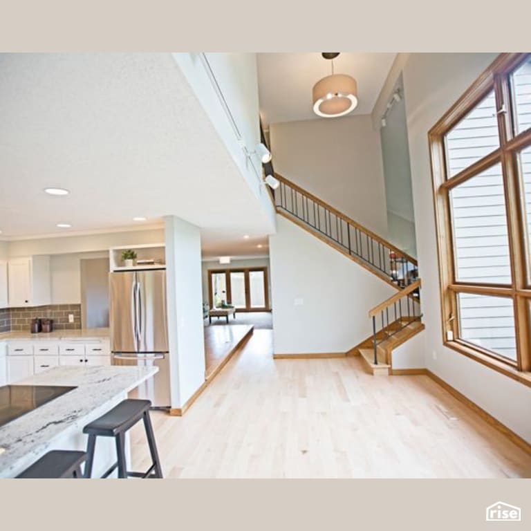 Staircase and Kitchen with Induction Cooktop by Constructive Builders