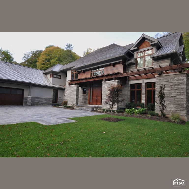 Stone house with stone driveway with Wood Mulch by Masonal Stone Inc