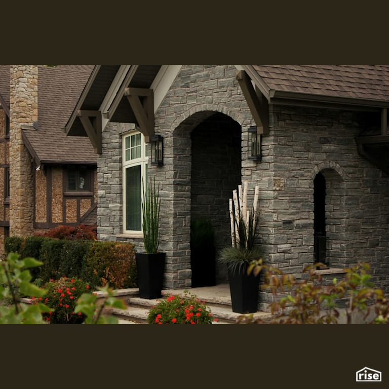 Stone arch entryway with Accent Outdoor Lighting by Masonal Stone Inc