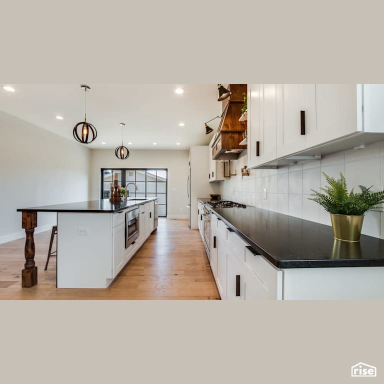 Open concept kitchen with wood features with Integrated LED by Revolve Design Build