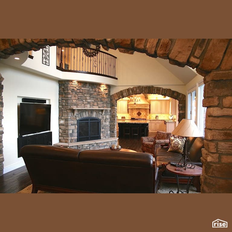 Large family room leading to kitchen with Gas Range by Revolve Design Build