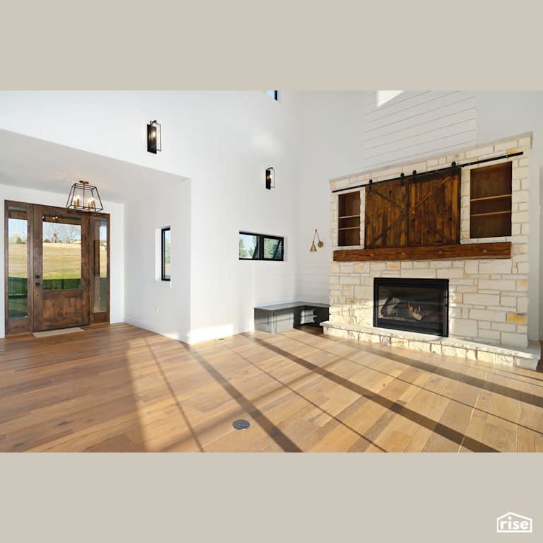 Entryway leading to stone feature gas fireplace with Solid Wood Door by Revolve Design Build
