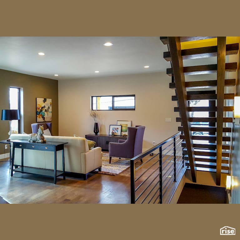 Living room with floating wood staircase and industrial metal railing with Sliding Window by Alpen High Performance Products