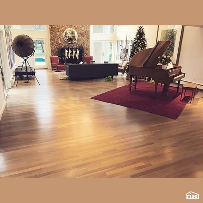 Great room with finished wood flooring and a paino with Interior Wood Finish by Vermont Natural Coatings