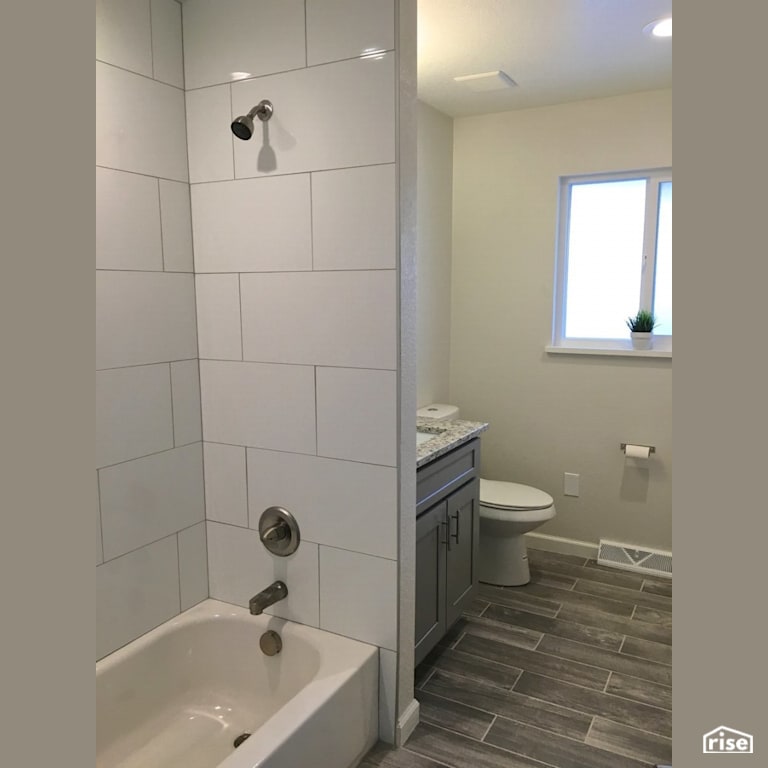 White tiled bathroom with grey ceramic tile floors with Ceramic Tile Floors by Revolve Design Build