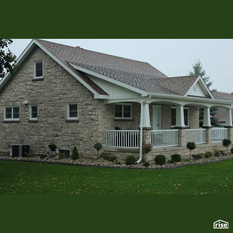 House with stone siding and porch with Energy Star Exterior Door by Masonal Stone Inc