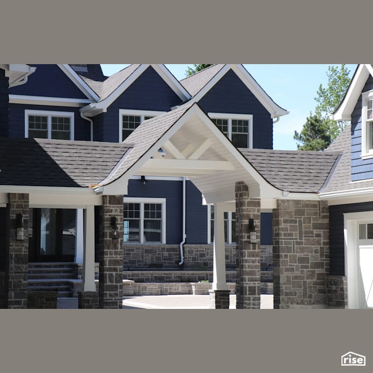 Large blue home with stone siding with Stone Siding by Masonal Stone Inc