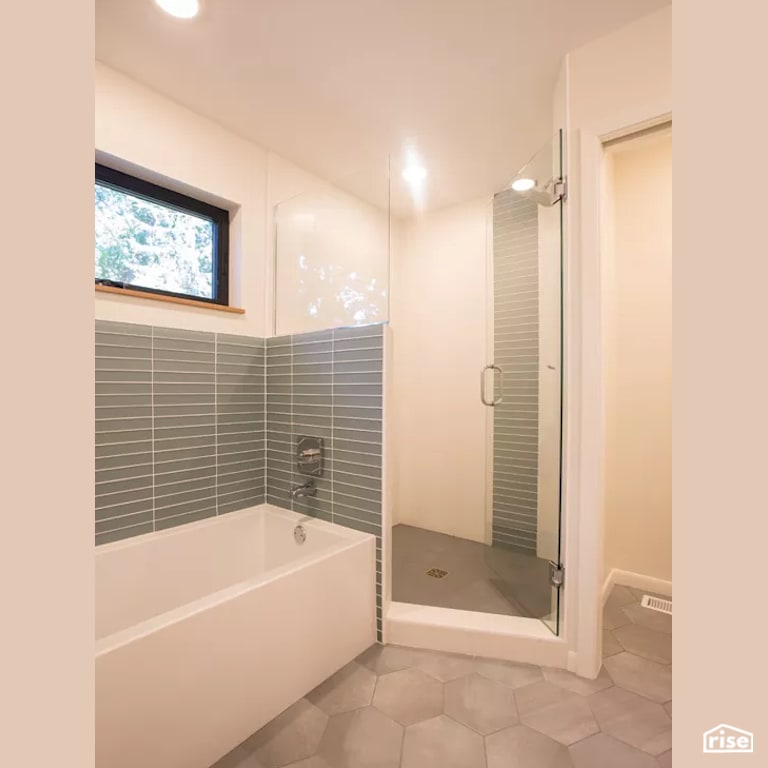 Bathroom with Low-Flow Showerhead by Constructive Builders
