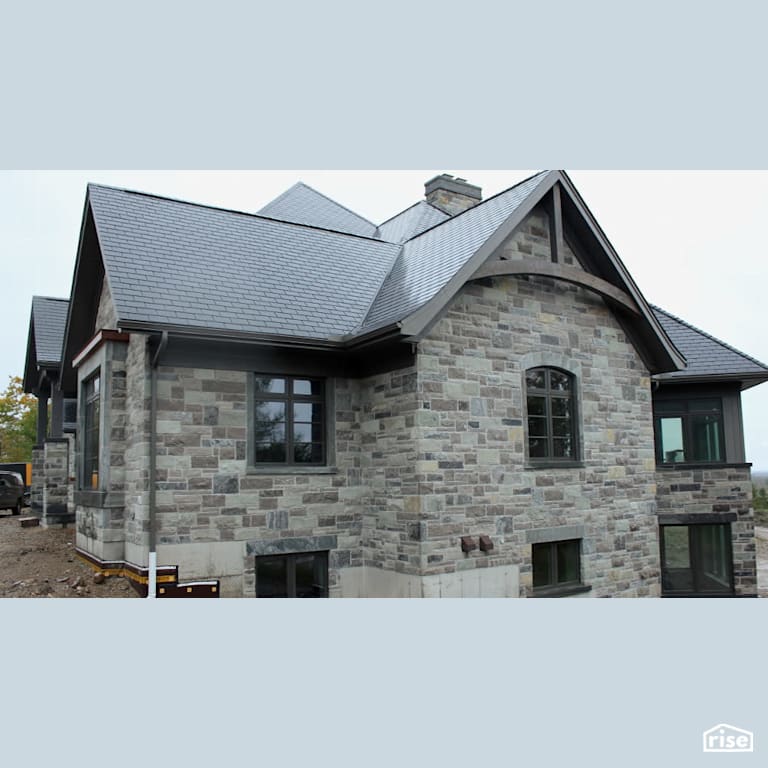 Stone house with synthetic slate roof with Stone Siding by Masonal Stone Inc