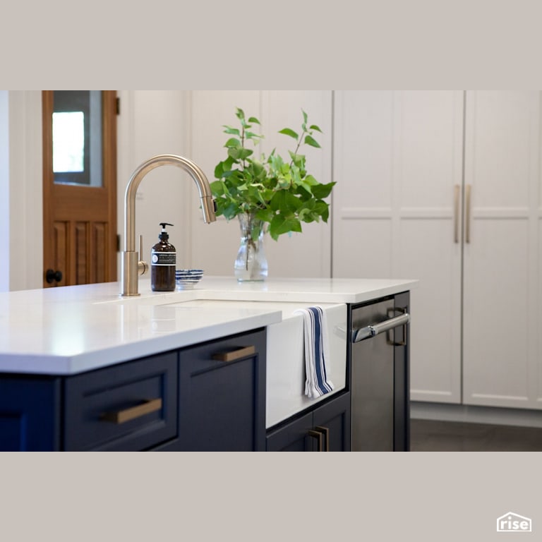 Blkue kitchen cabinets with gold accent low-flow faucet with Low-Flow Kitchen Faucet by J Russon Construction