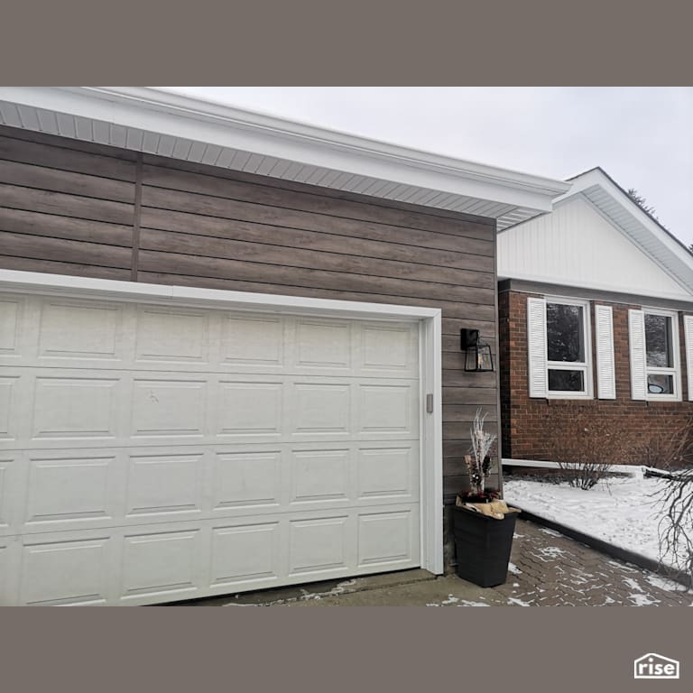 Garage with composite siding with Accent Outdoor Lighting by ChamClad by Chameleon