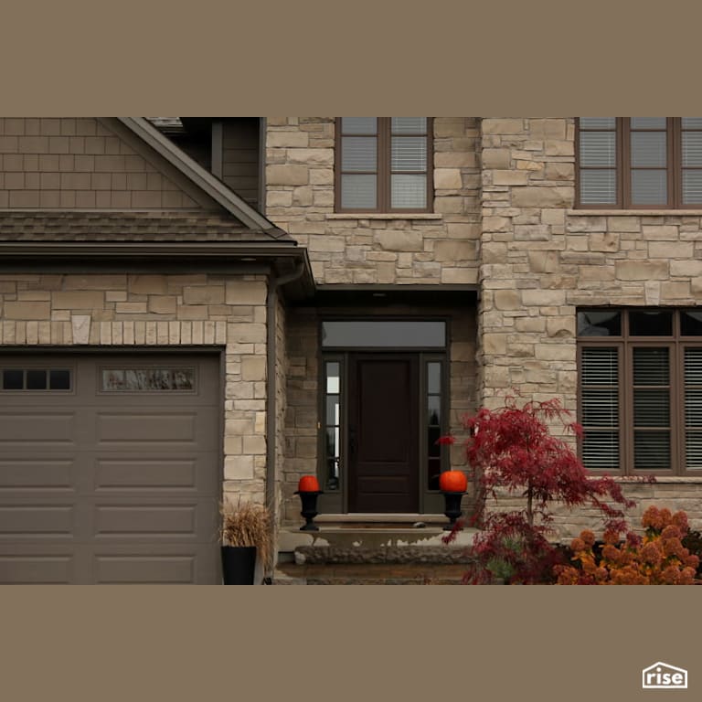 Stone home with brown front door with Stone Siding by Masonal Stone Inc