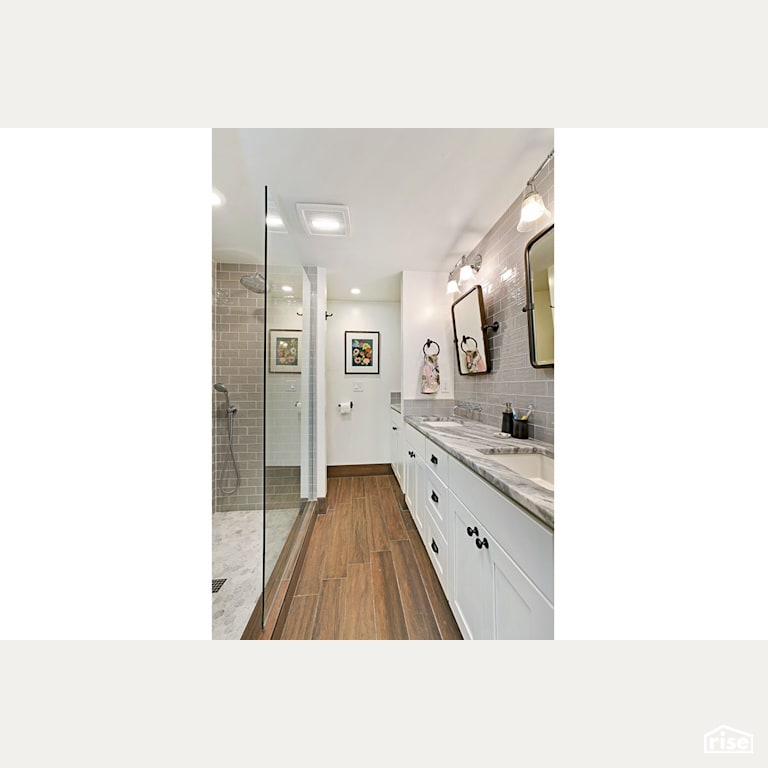 White bathroom with wood grain flooring with Low-Flow Showerhead by Gant Nychay Architecture PLLC