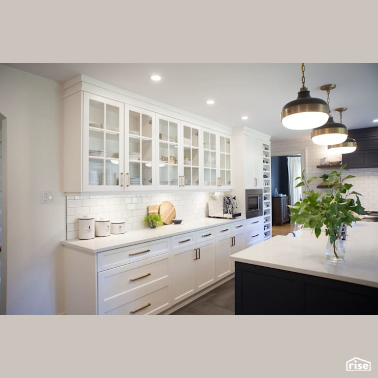 Glass kitchen cabinet doors above white subway tile with Integrated LED by J Russon Construction