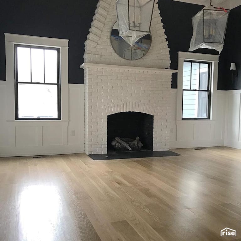 Finished wood flooring around white fireplace with Interior Wood Finish by Vermont Natural Coatings