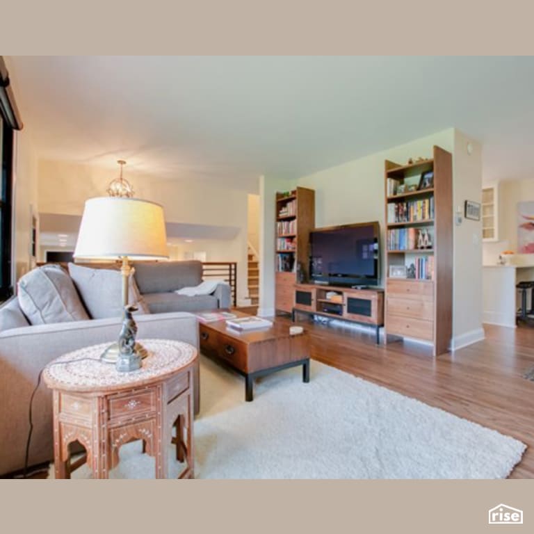 Living Room with Laminate Flooring by Constructive Builders